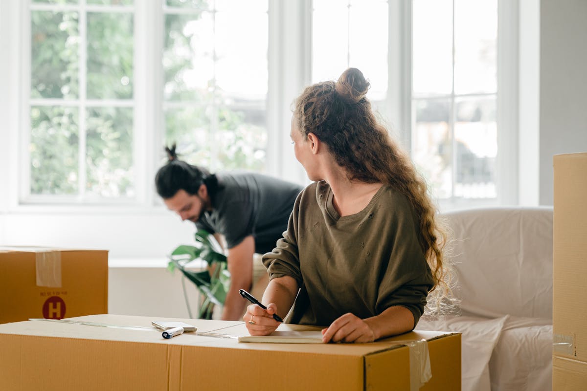 Multiracial couple with pile of boxes preparing to relocate