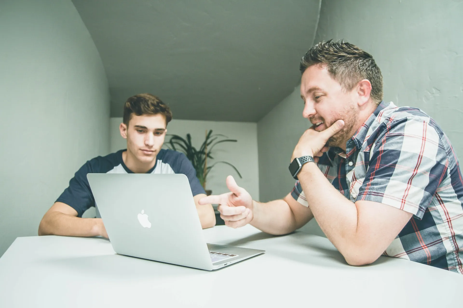 Real estate mentor discussing business plan with his mentee.