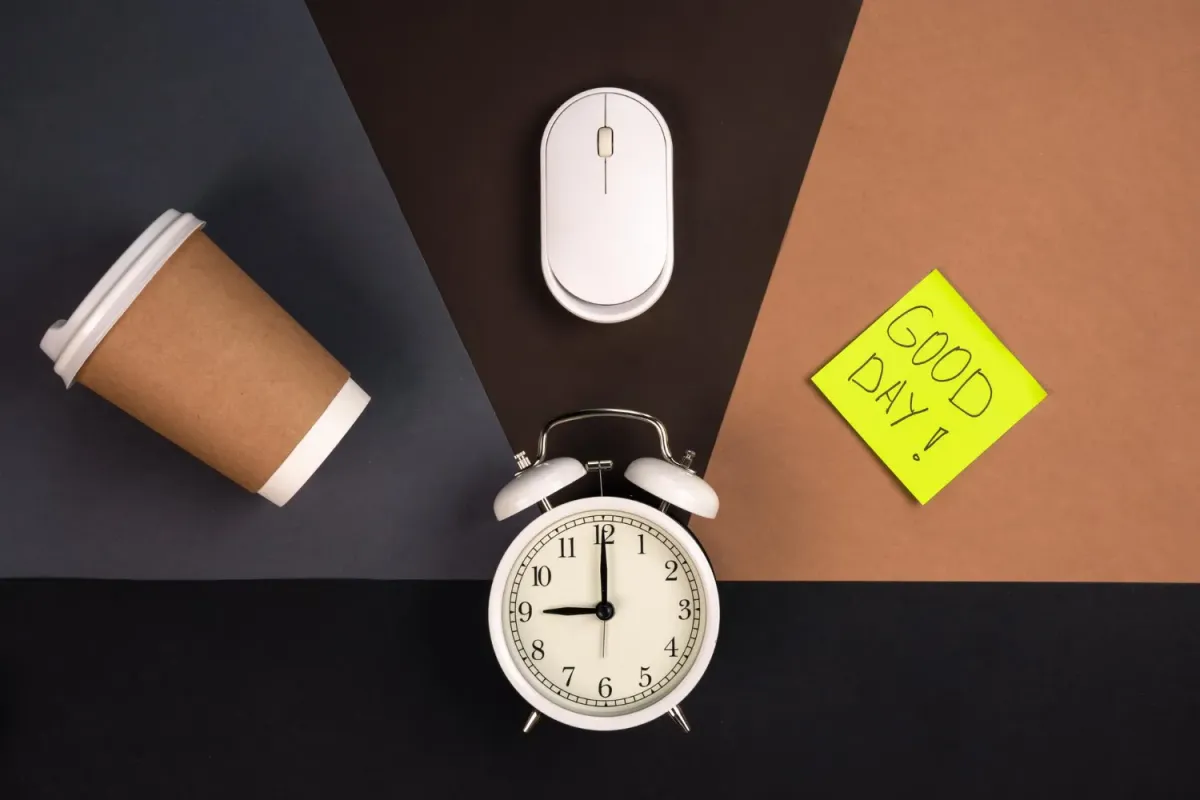 Alarm clock computer mouse paper cup and bright paper sticker top view