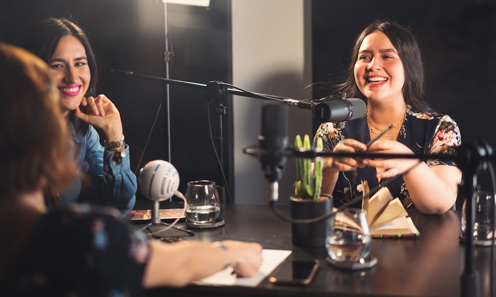 Ladies sharing their success stories on a real estate podcast