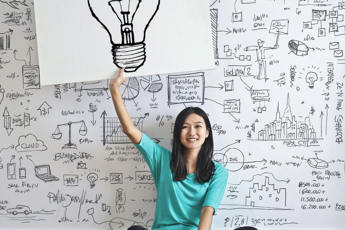 Girl sitting with a bright idea.