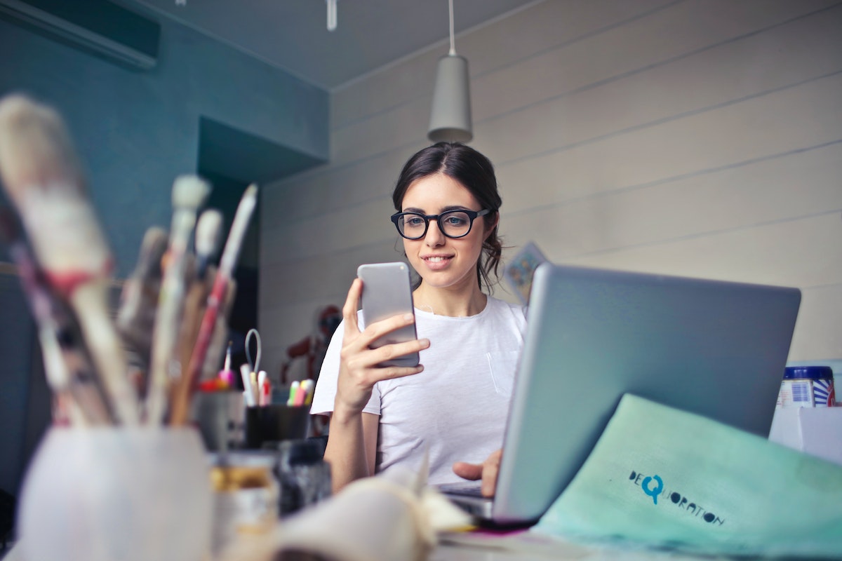 Woman using the mobile app of free real estate CRM software.