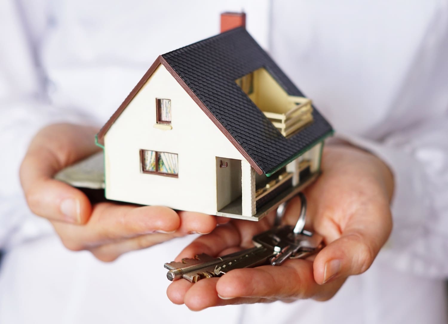 closeup shot of a person thinking of buying or selling a house