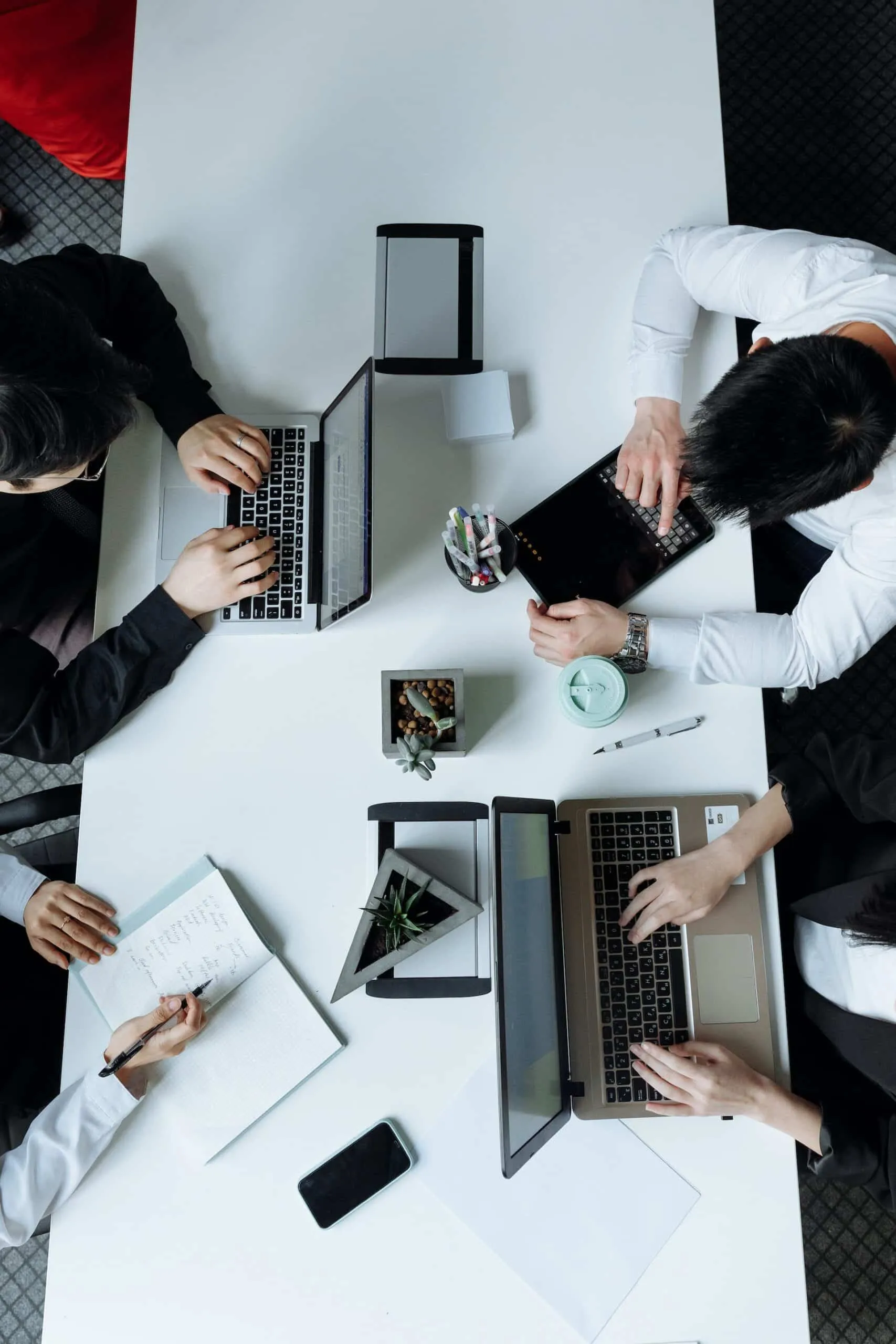 People around a desk using digital marketing tools.