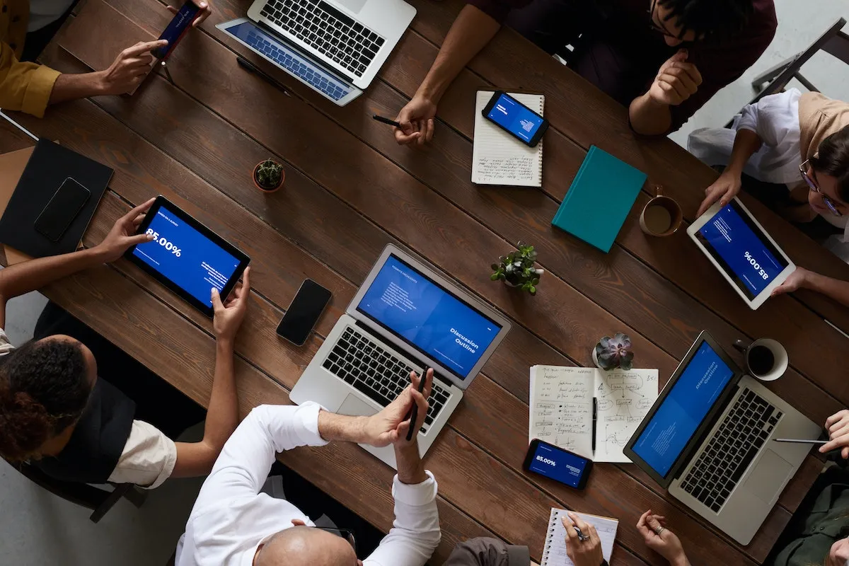 People around a table discussing a real estate marketing tool.