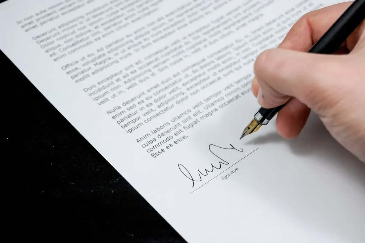 Person signing a document.