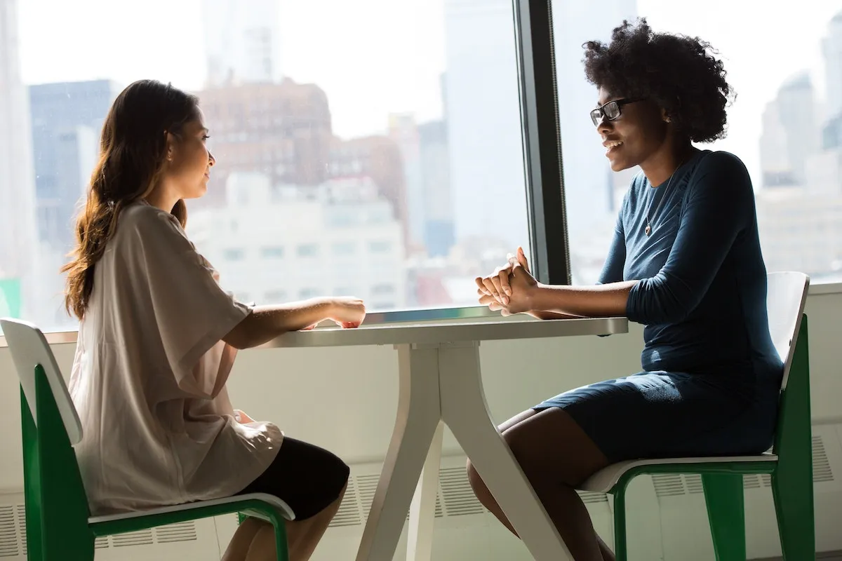 Two businesswomen planning real estate marketing campaigns.