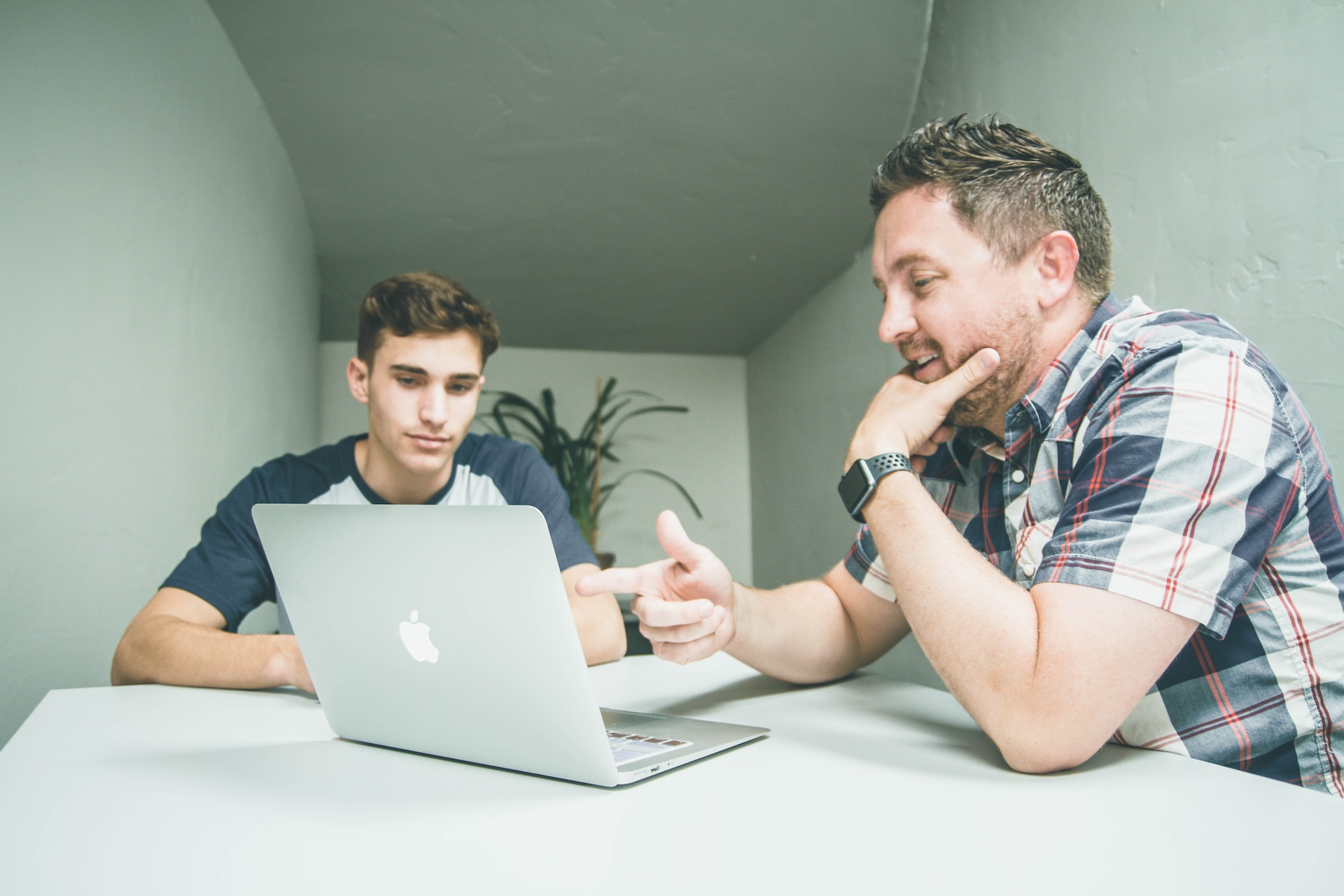 Real estate mentor discussing business plan with his mentee.