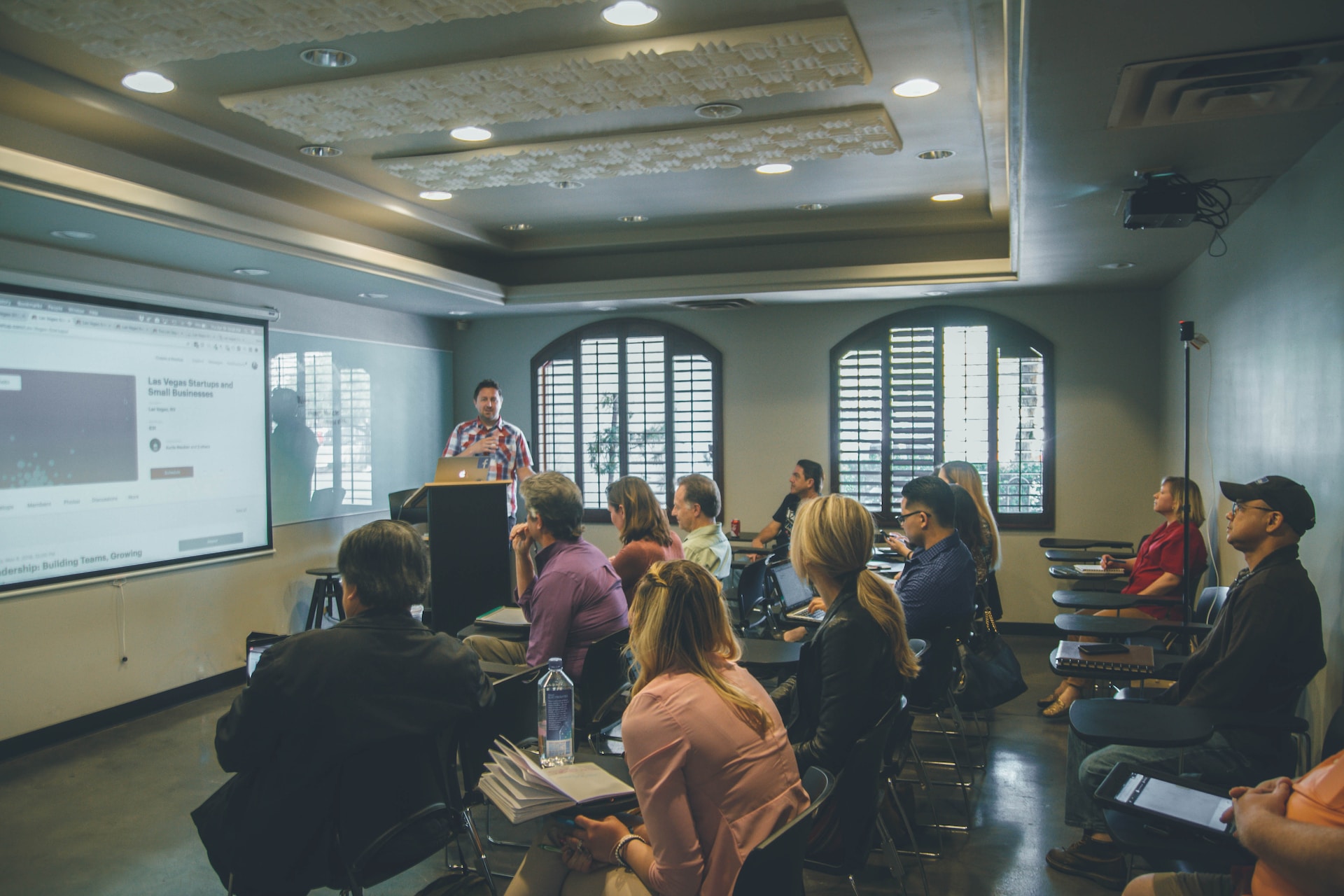 Room of agents listening to a real estate coach.