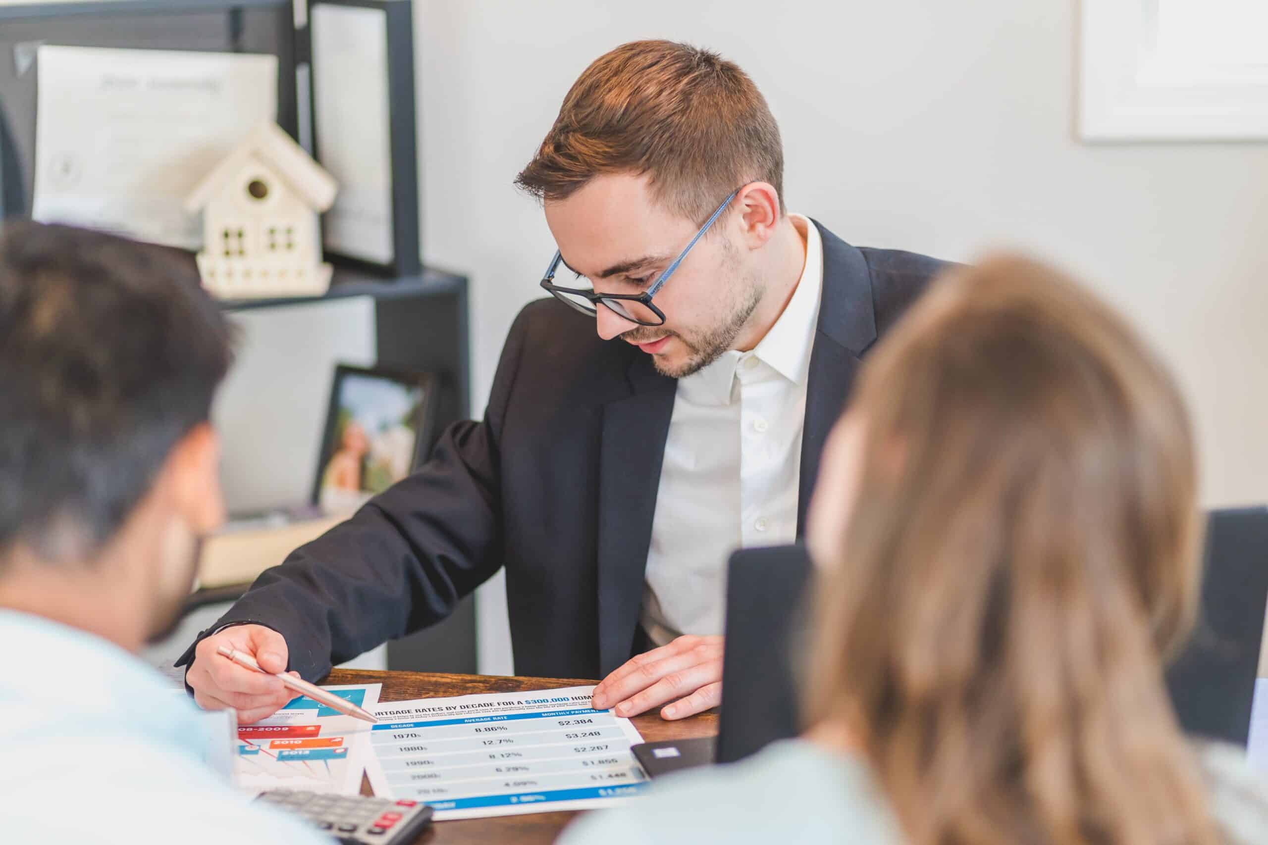 realtor discussing selling homes with his clients