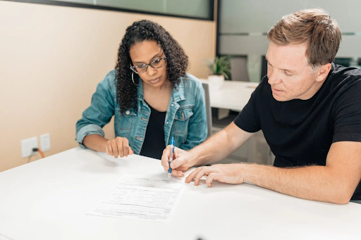 woman and man signing a contract