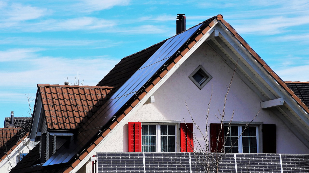 green building trends – home with solar panels and large windows