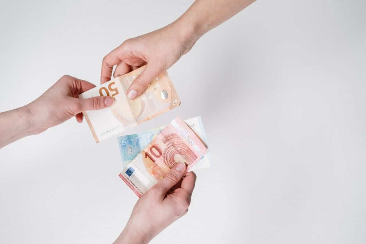 Person Holding 10 and 10 Euro Banknotes