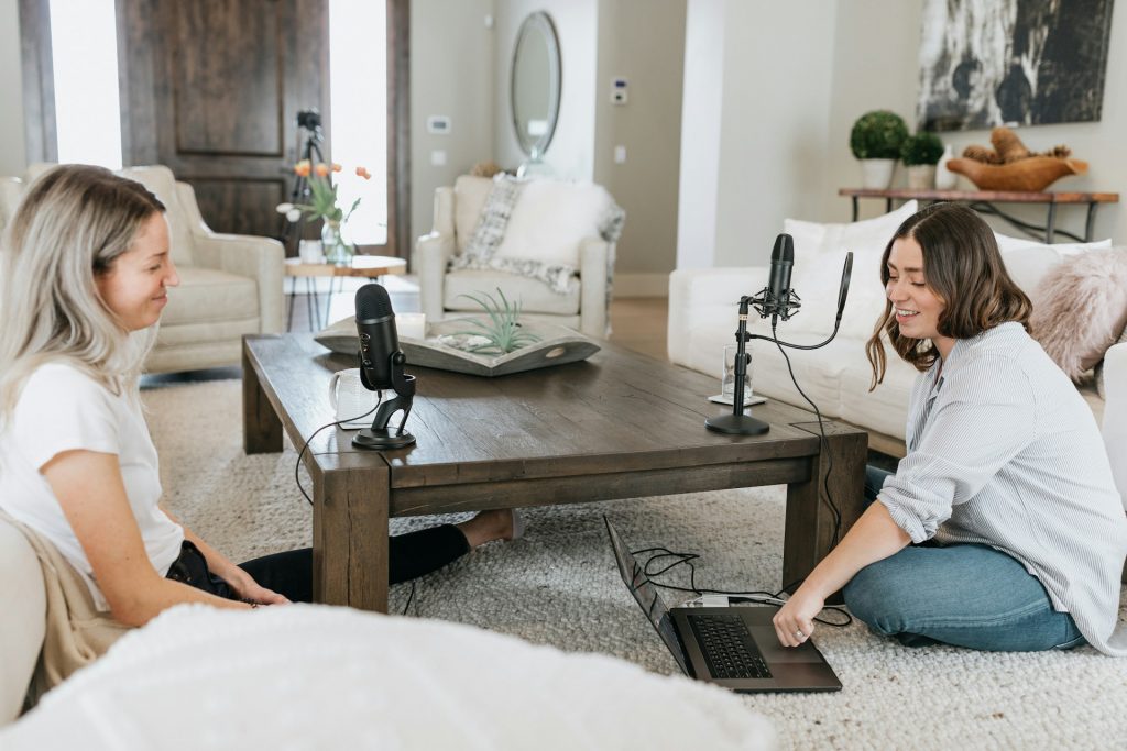 Person in white shirt using black laptop computer on brown wooden table photo