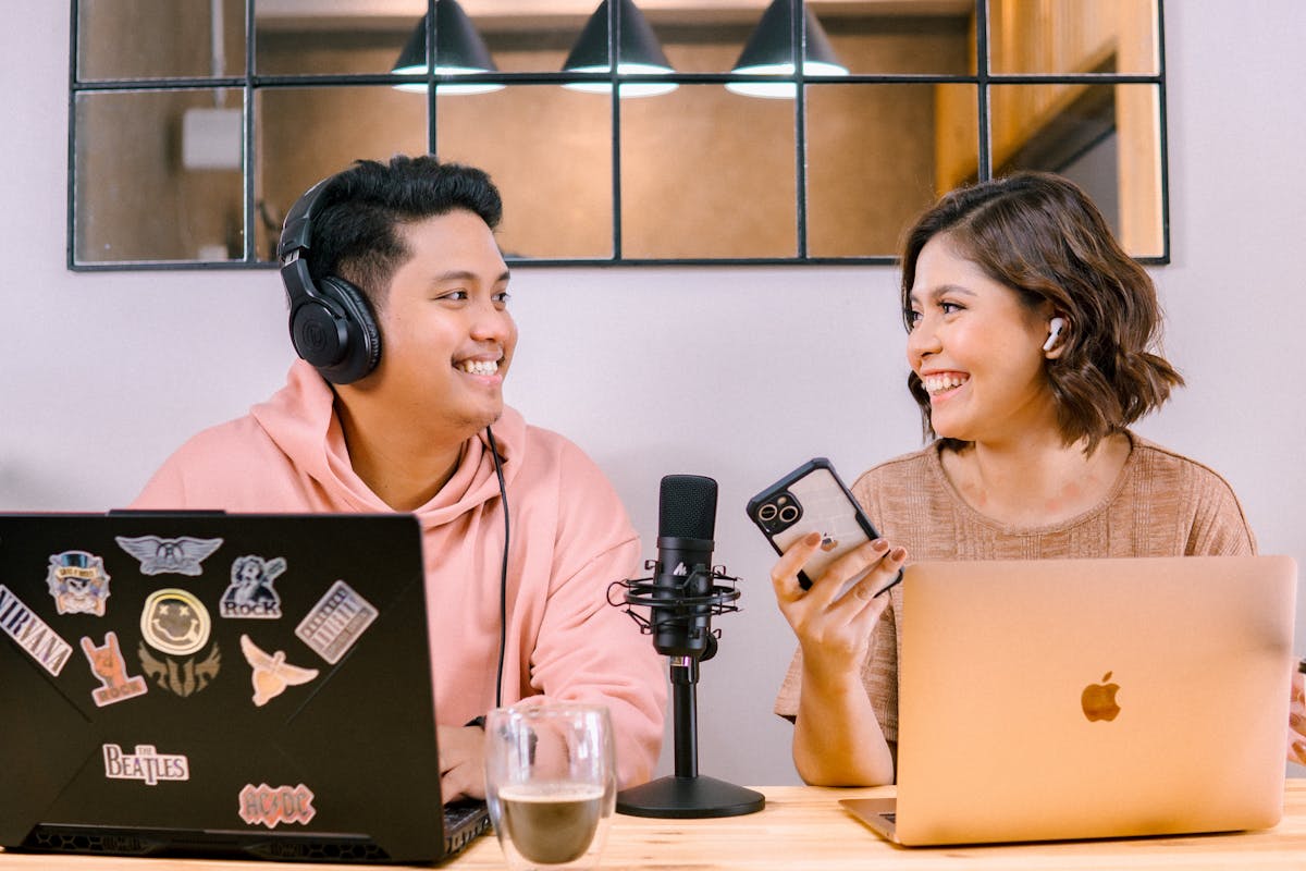 Man and Woman Looking at Each Other While Doing Podcast